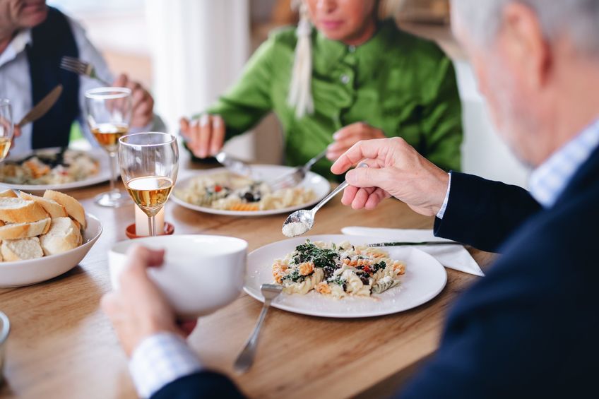 Family eating dinner at dinning room table in remodeled room